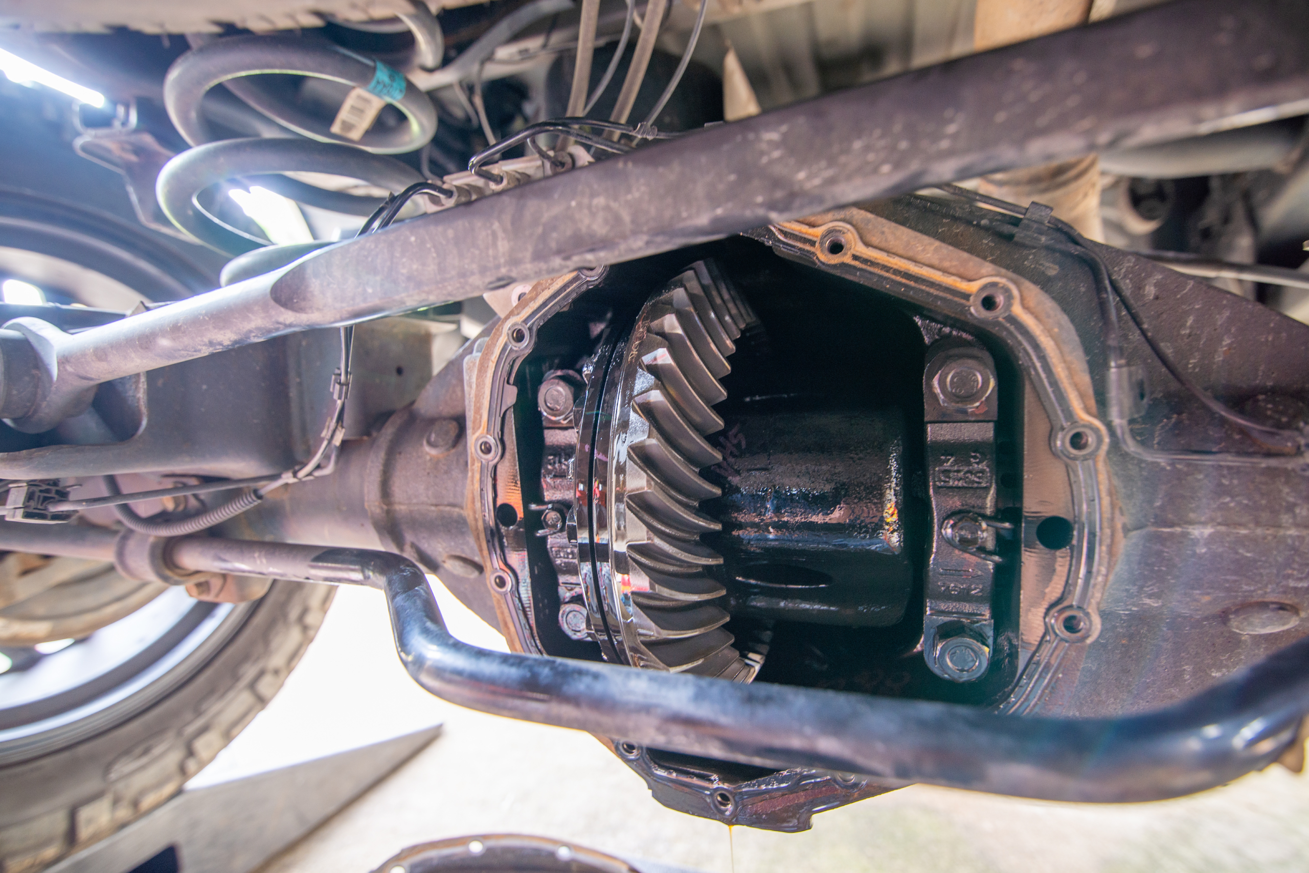 Close-up of an opened differential assembly on a vehicle chassis during inspection for differential repair in Edmonton.